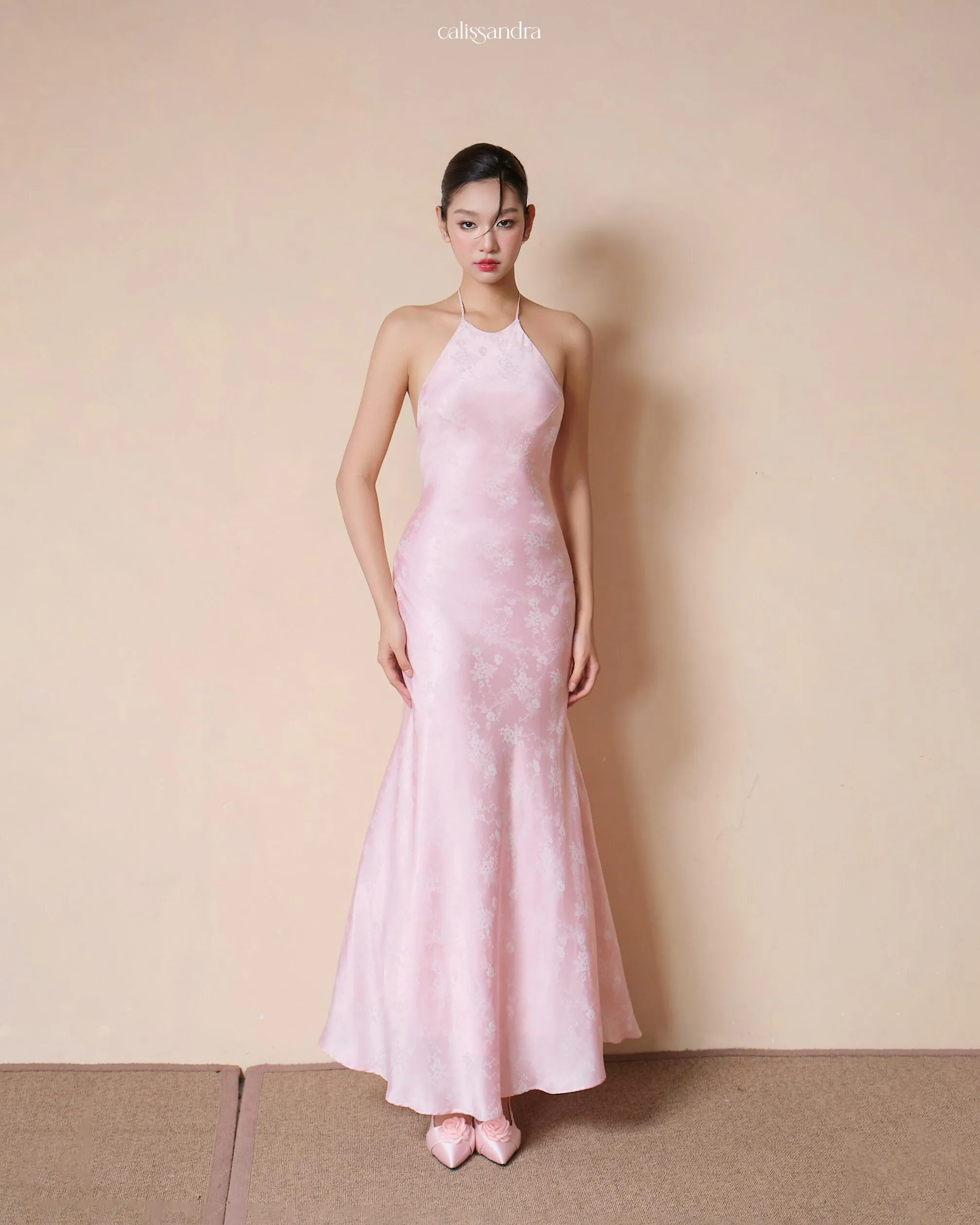 Full-length view of Blossarie luxury pastel pink floral jacquard silk evening gown, featuring a halter neck and a sleek mermaid silhouette by Calissandra