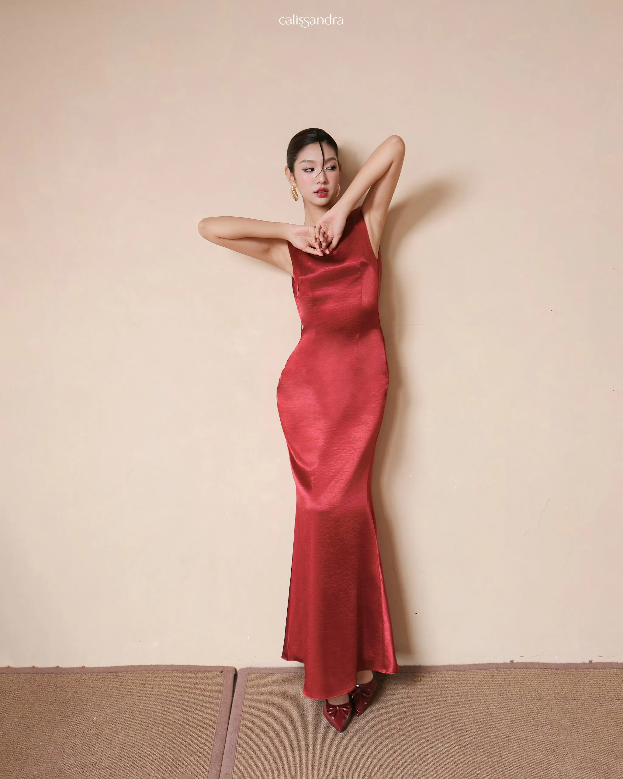 Full-length view of Crimoria luxury crimson red silk satin evening gown, featuring an elegant boat neckline and a sleek column silhouette by Calissandra