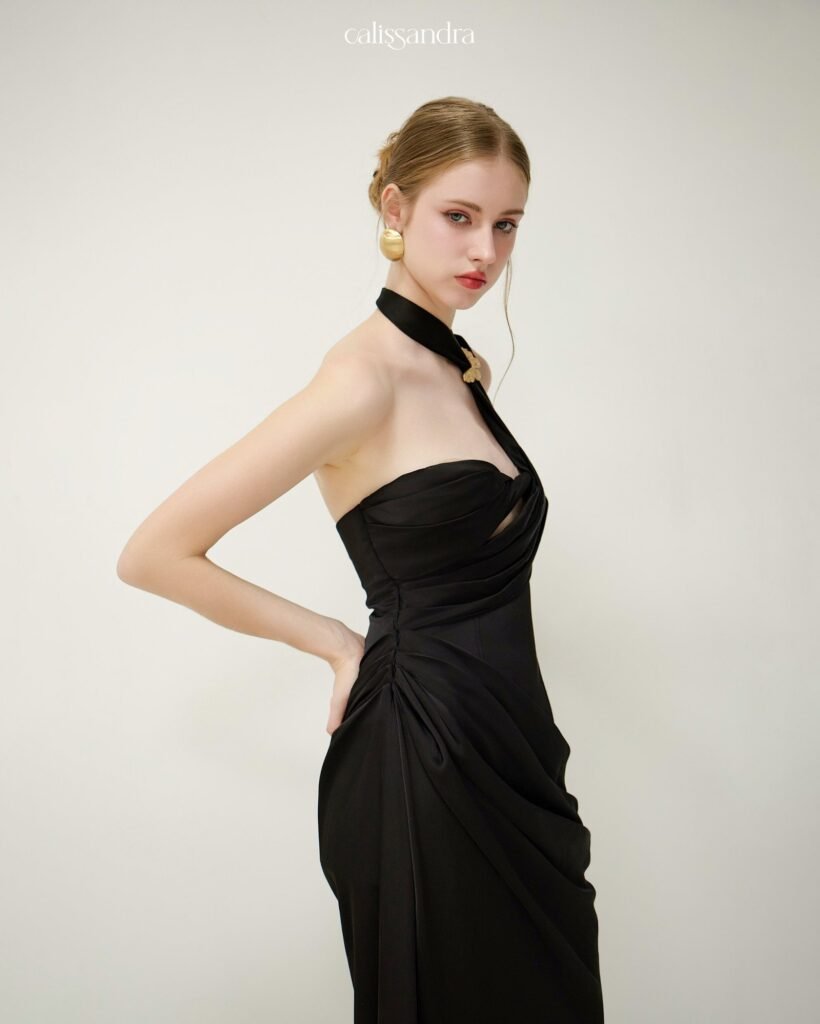Model wearing a black Calissandra one-shoulder evening dress, front view