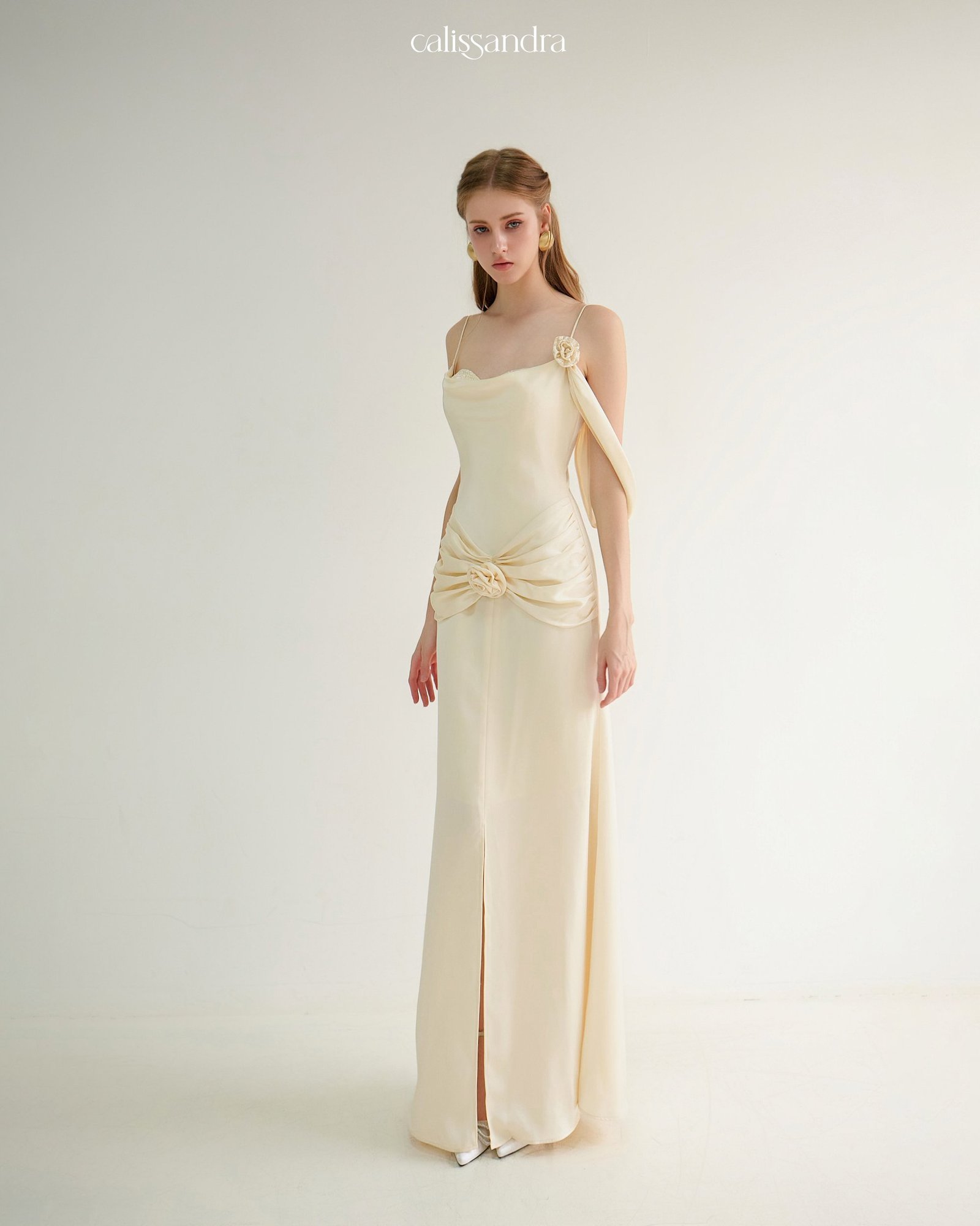 Model wearing the Calissandra Auriane Cream Ivory 3d Rose Draped Dress, front view