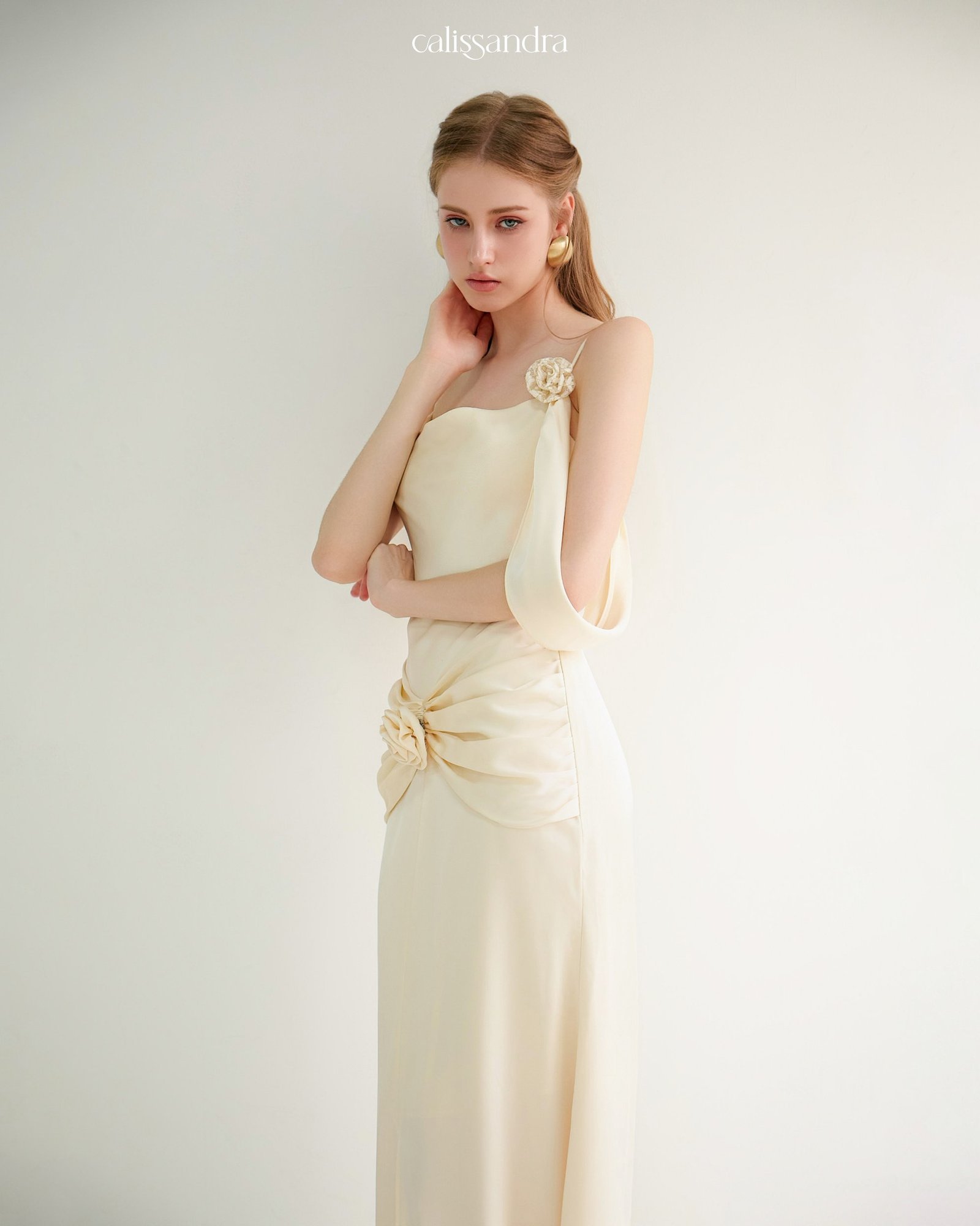 Model wearing the Calissandra Auriane Cream Ivory 3d Rose Draped Dress, front view