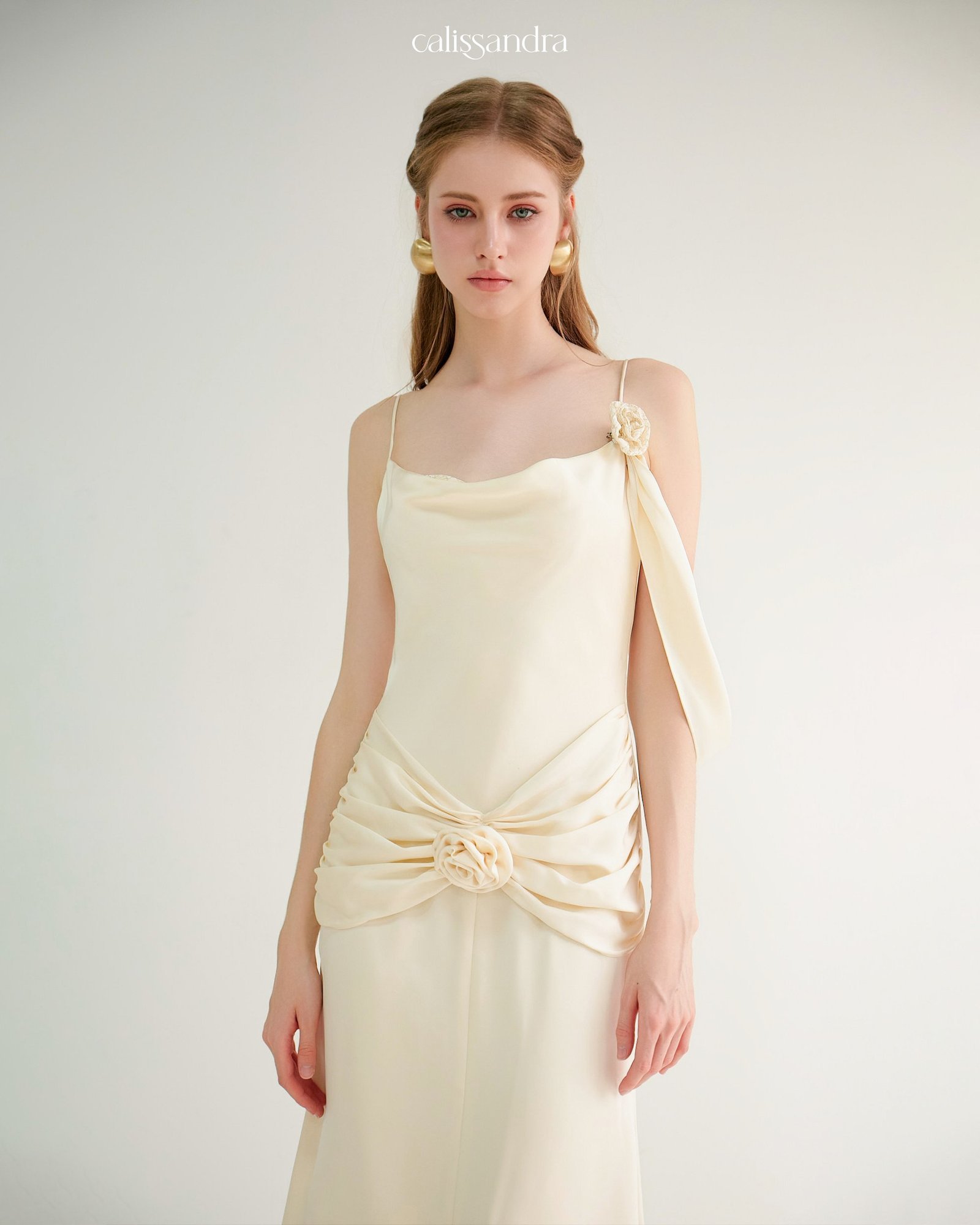 Model wearing the Calissandra Auriane Cream Ivory 3d Rose Draped Dress, front view