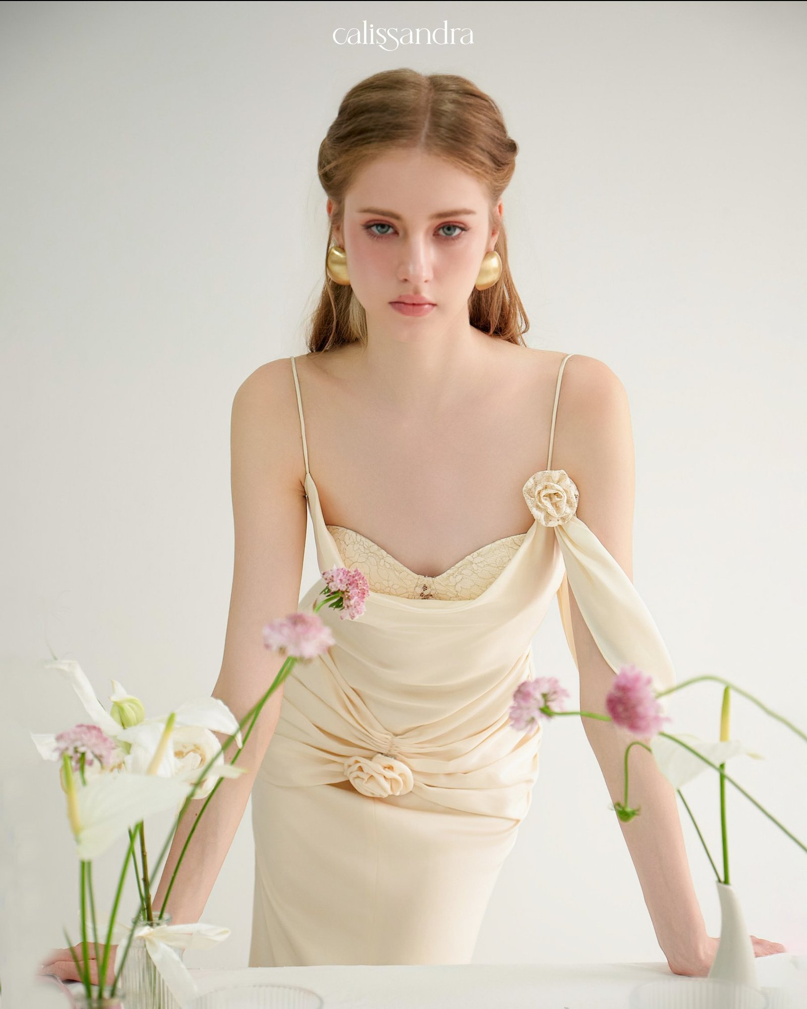 Model wearing the Calissandra Auriane Cream Ivory 3d Rose Draped Dress, front view