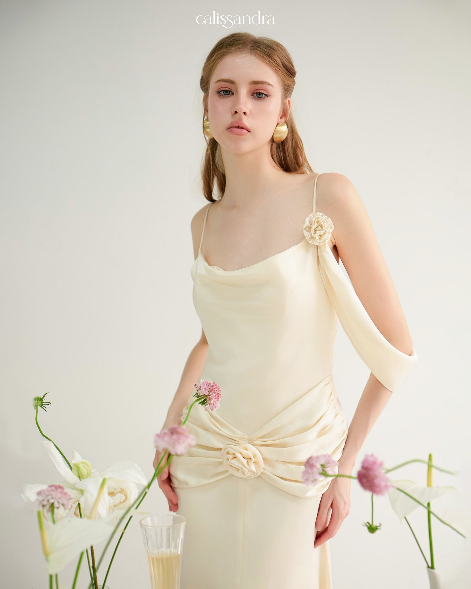 Model wearing the Calissandra Auriane Cream Ivory 3d Rose Draped Dress, front view