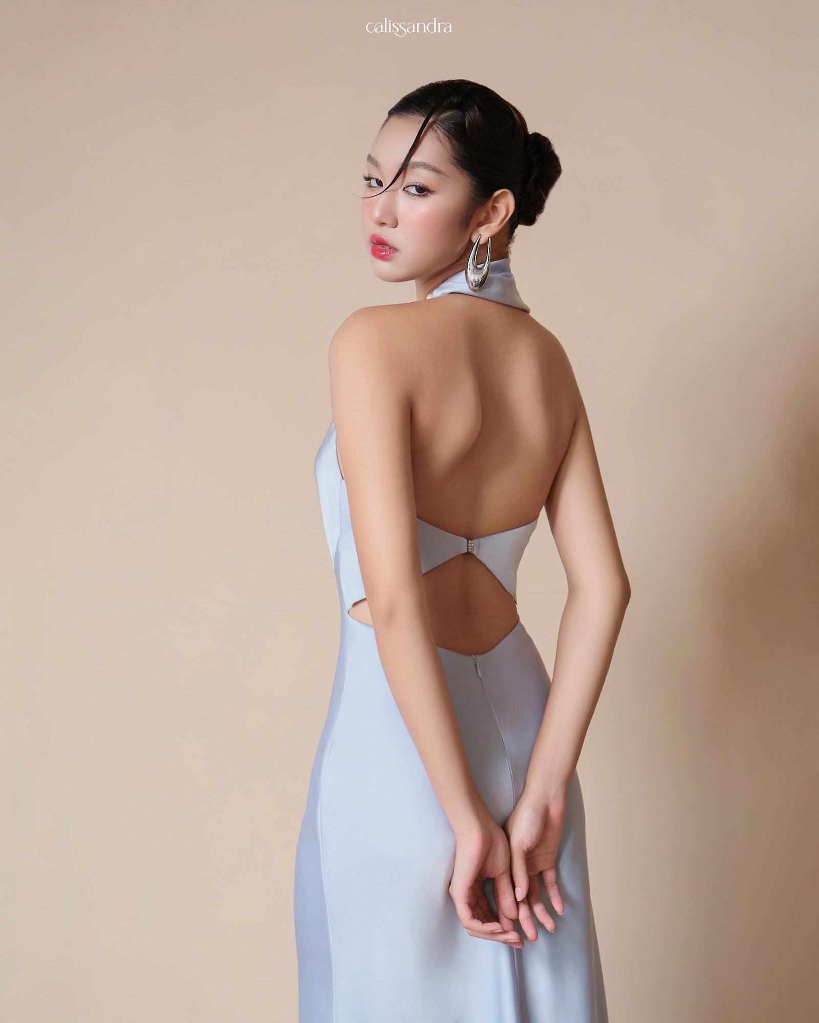 Model wearing the Calissandra Lunaria Ice Blue Silk Dress, back view